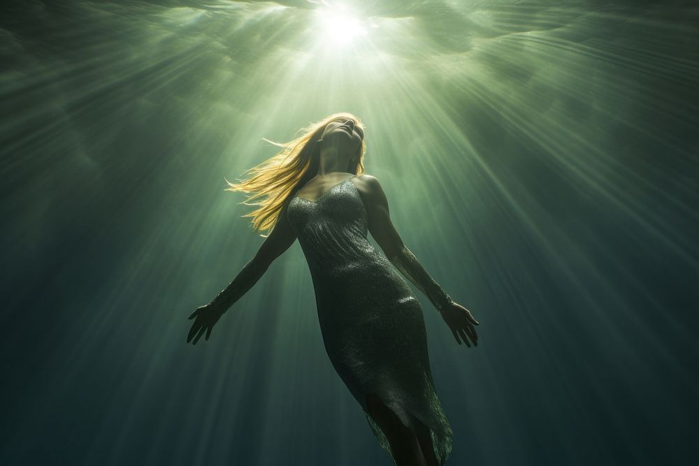 Mermaid swimming underwater sunlight. AI generated Image by rawpixel.
