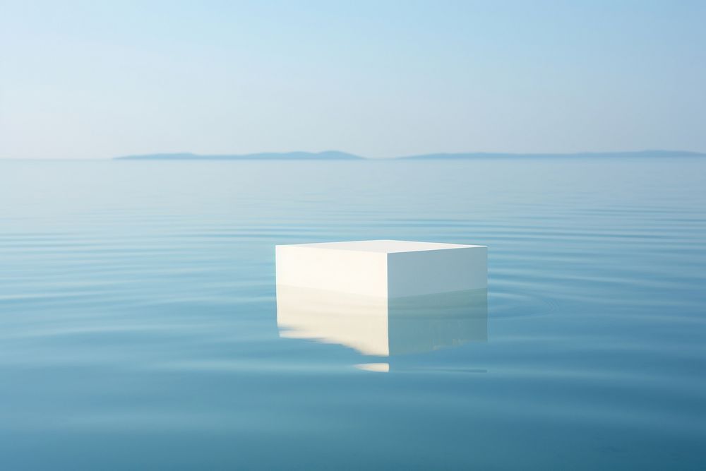 White product podium rests delicately on the surface of crystal-clear water outdoors horizon nature. AI generated Image by…