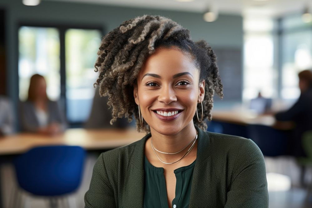 African Woman with dreadlocks smiling at the camera during a meeting in a business office adult smile woman. AI generated…