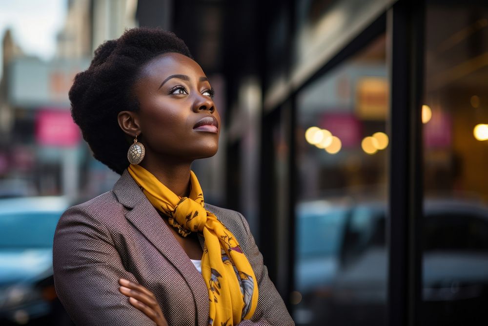 African businesswoman looking sideways while waiting for a cab in the morning portrait scarf photo. AI generated Image by…