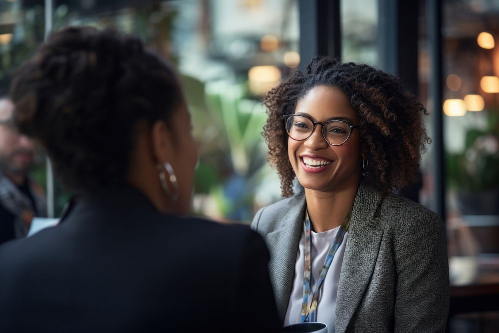 Beautiful smiling African business lady chatting with coworker adult smile happy. AI generated Image by rawpixel.