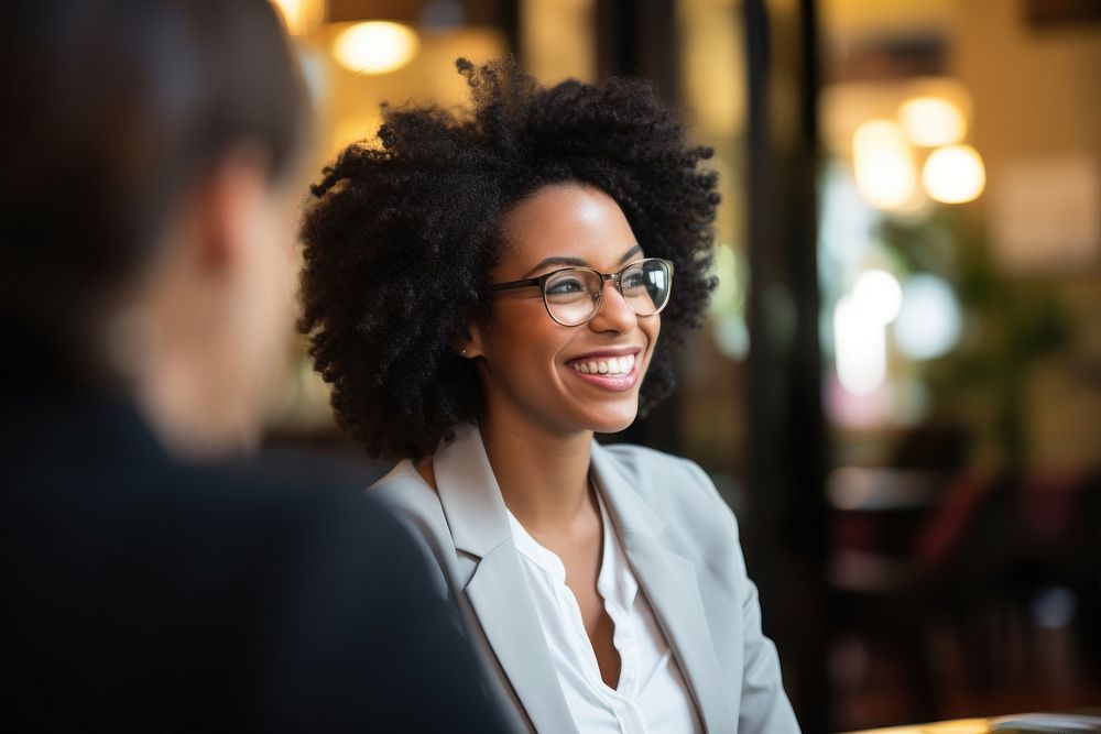 Beautiful smiling African business lady chatting with coworker glasses adult smile. AI generated Image by rawpixel.
