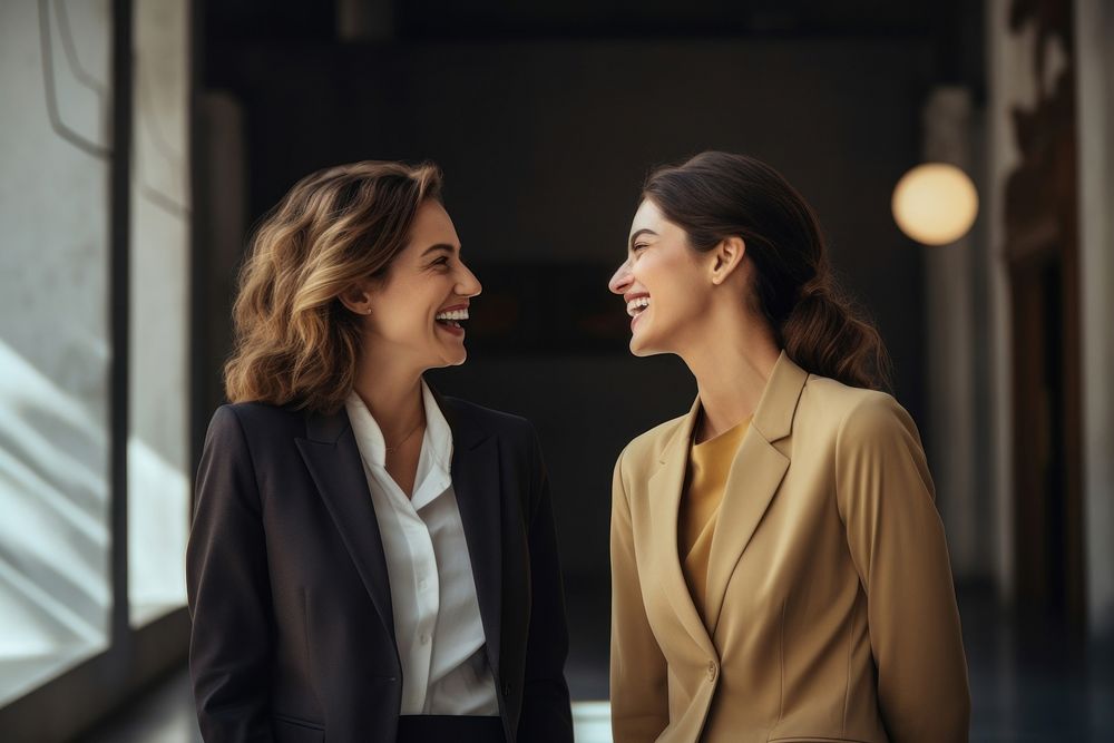 Happy female business colleagues communicating with each other laughing smile adult. AI generated Image by rawpixel.