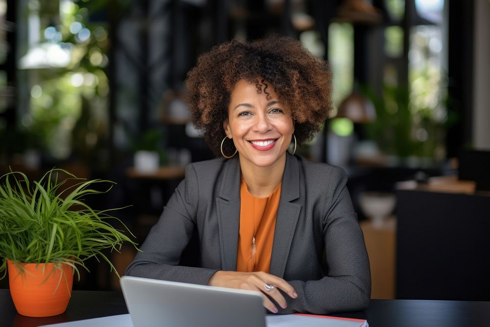 Mature cheerful african american executive businesswoman at workspace computer laptop adult. AI generated Image by rawpixel.