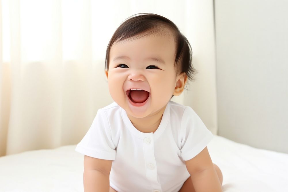 Cute baby asian laughing beginnings relaxation happiness. AI generated Image by rawpixel.