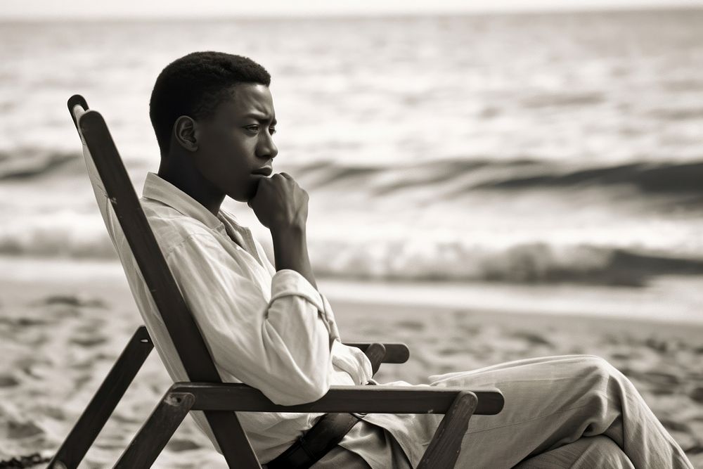 African American man sitting sea portrait. AI generated Image by rawpixel.