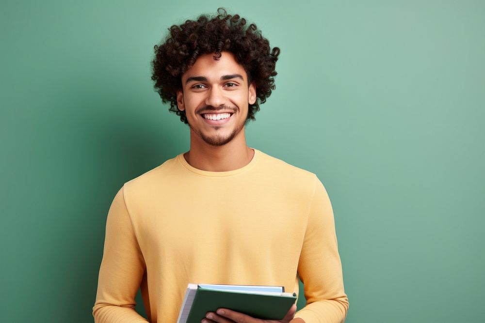 A smile student adult men holding book portrait intelligence publication. AI generated Image by rawpixel.