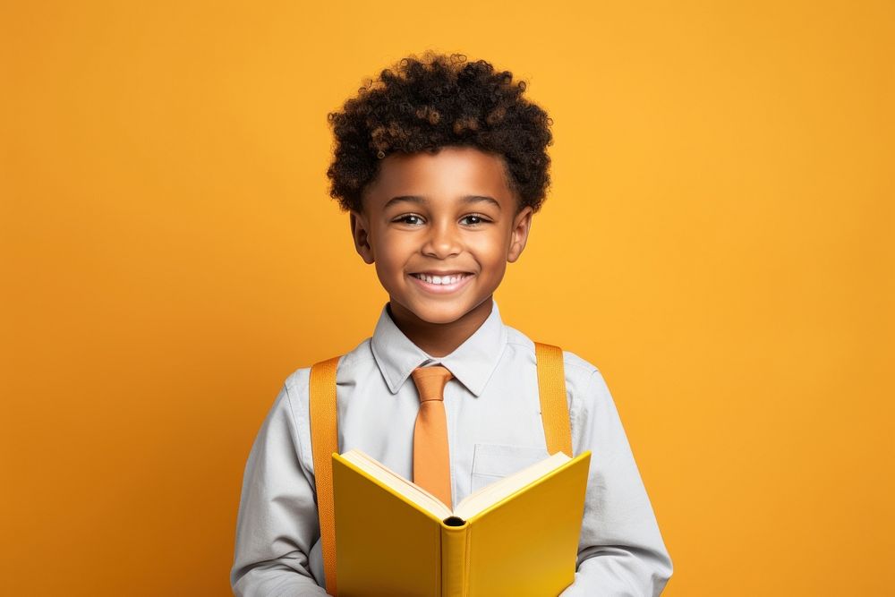 A smile student african boy holding book portrait reading child. AI generated Image by rawpixel.