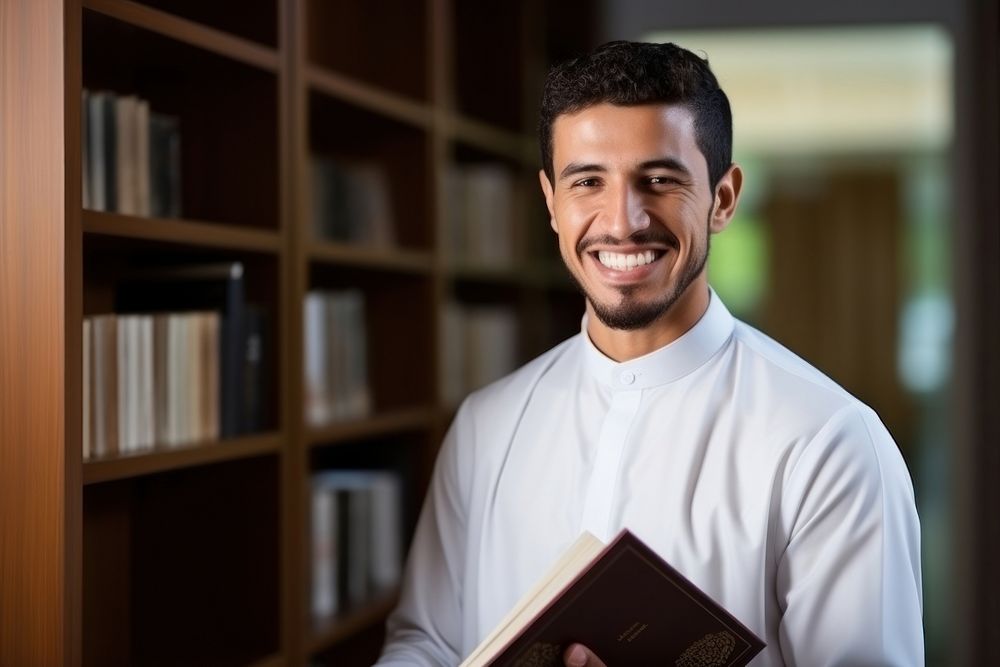 A smile student muslim men holding book publication portrait adult. AI generated Image by rawpixel.
