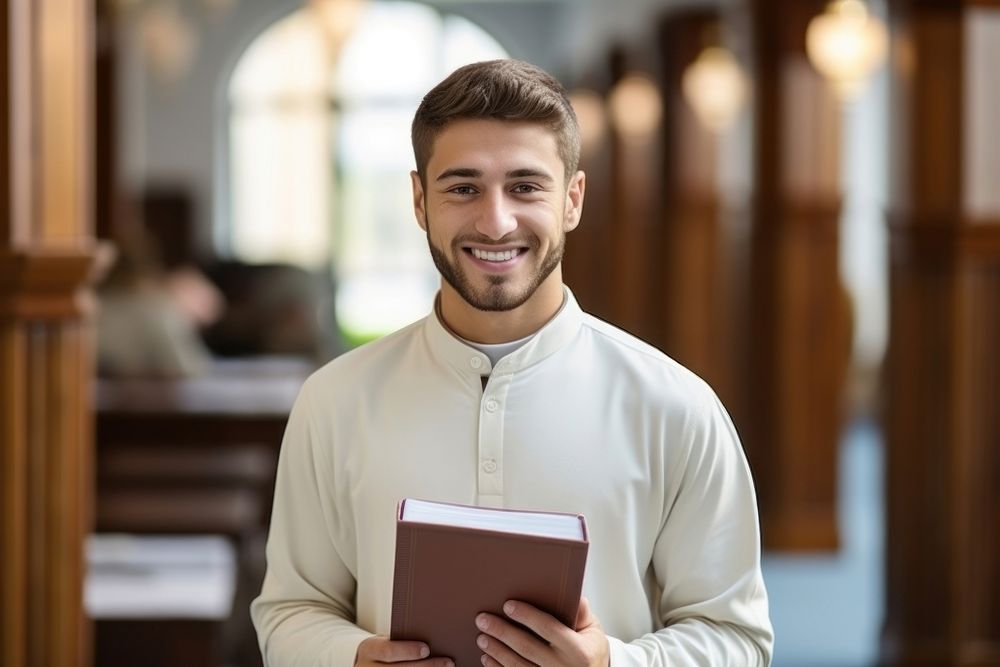 A smile student muslim men holding book portrait adult spirituality. AI generated Image by rawpixel.