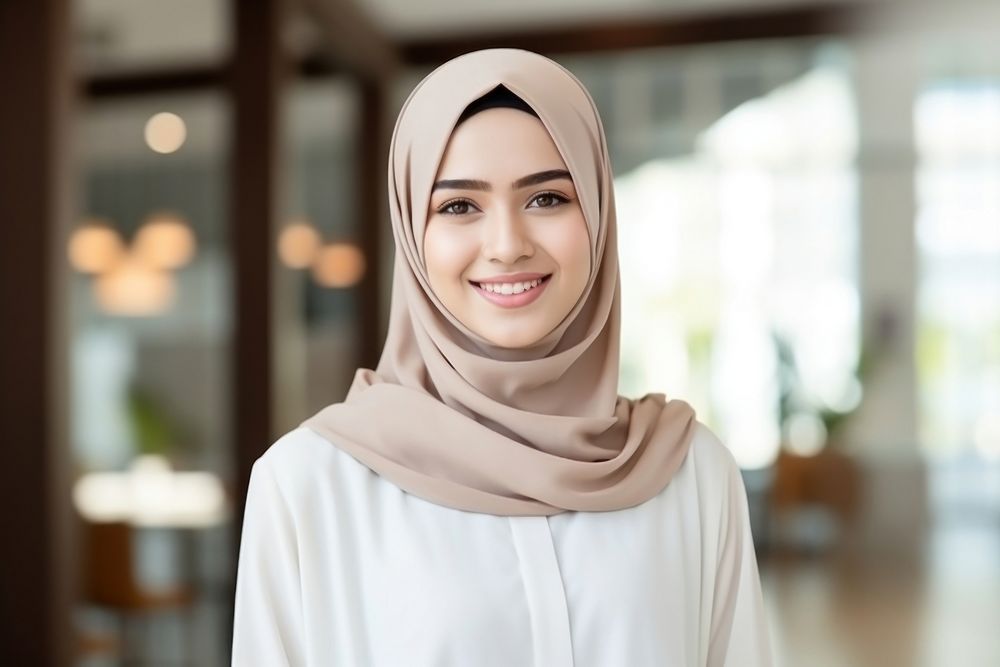 A smile student muslim woman holding book portrait scarf headscarf. AI generated Image by rawpixel.