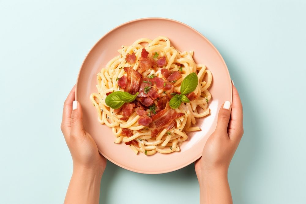 Bacon pasta dish spaghetti holding plate. AI generated Image by rawpixel.