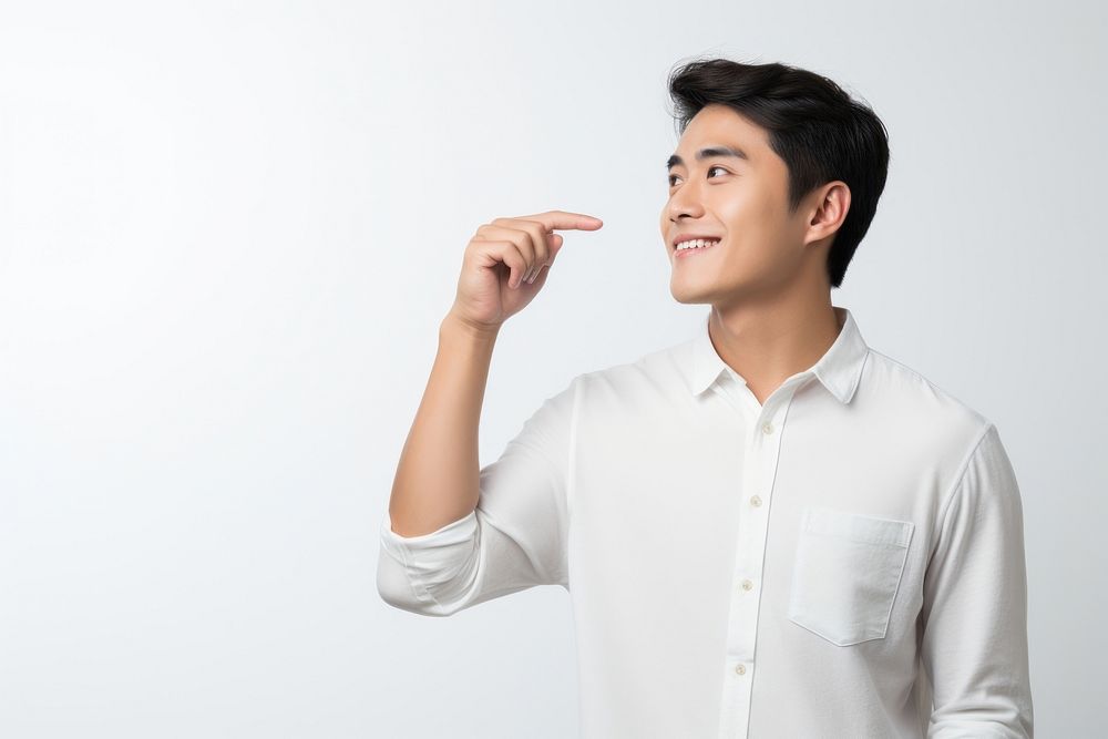 Asian man is pointing holding adult white background. AI generated Image by rawpixel.