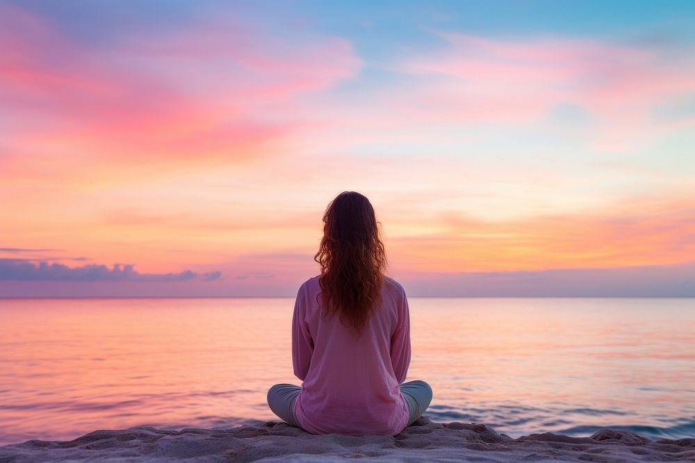 Woman meditating on the beach sky outdoors horizon. AI generated Image by rawpixel.