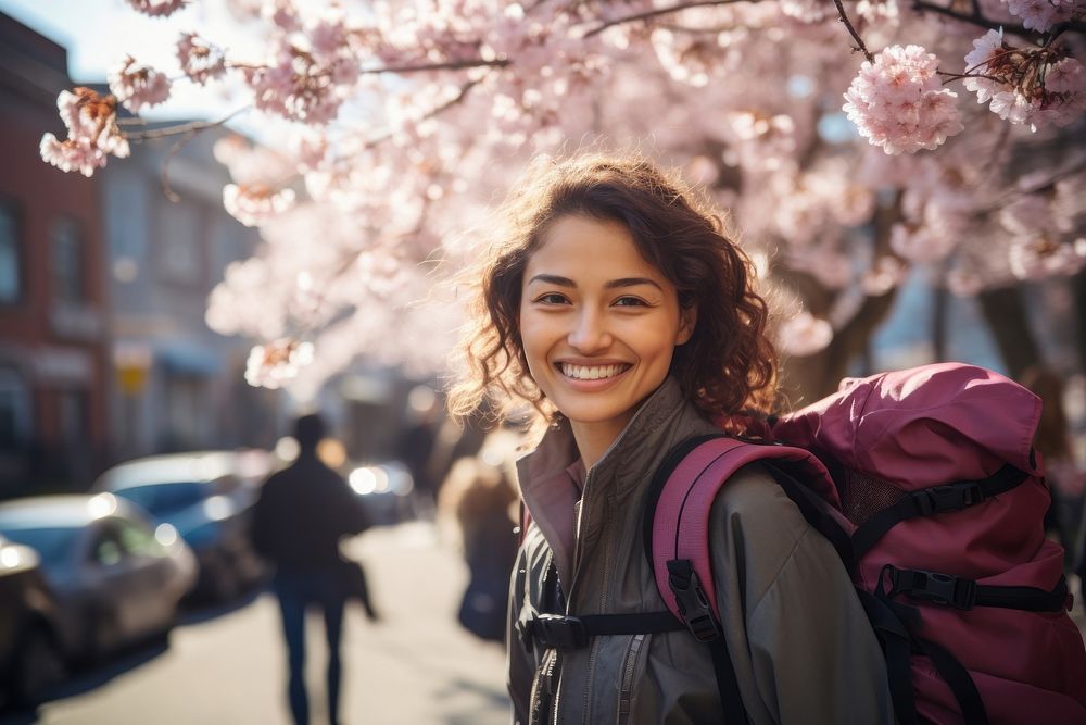 Smiling Latino women with backpack blossom flower travel. AI generated Image by rawpixel.