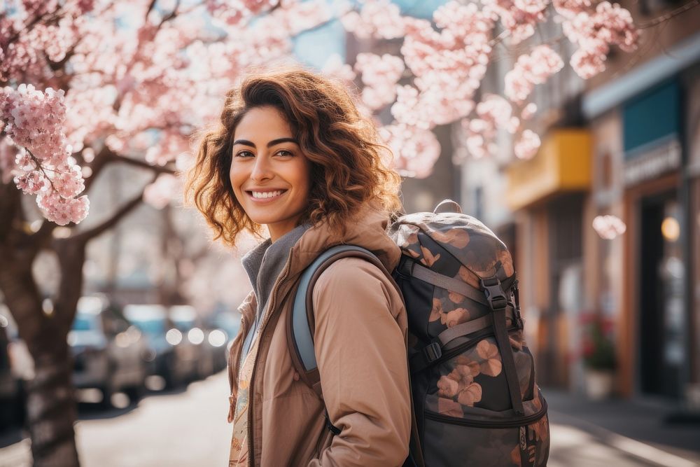 Smiling Latino women with backpack jacket travel street. AI generated Image by rawpixel.