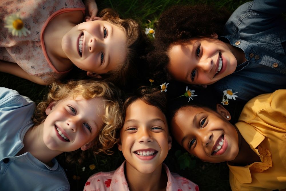 Kids lying down in a park smiling laughing portrait smile. AI generated Image by rawpixel.