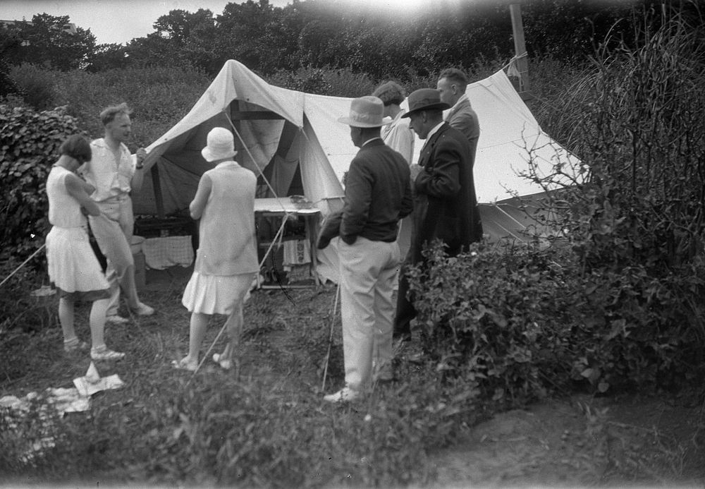 [Group standing around a tent] (1920s to 1930s) by Roland Searle.