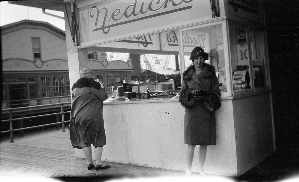 [Women at hotdog kiosk] (1920s to 1930s) by Roland Searle.