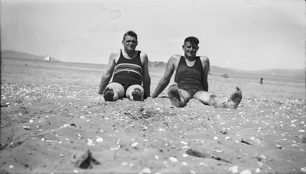 [Men seated on beach]. (1920s to 1930s) by Roland Searle.
