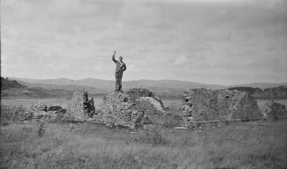 [Man standing on the ruins of a wall]. (1920s to 1930s) by Roland Searle.