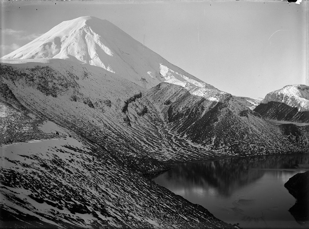 The snowy cone of Ngauruhoe with the "Big" Tama Lake in foreground. (August 1925) by Leslie Adkin.
