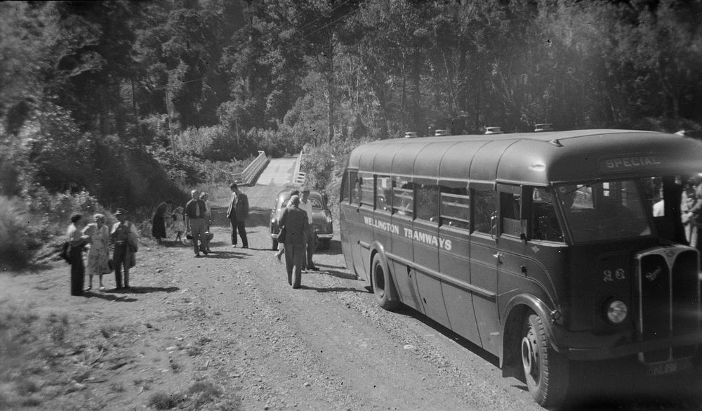 Bus and party on service road near lunch place (Pakuratahu) (28 March 1954) by Leslie Adkin.
