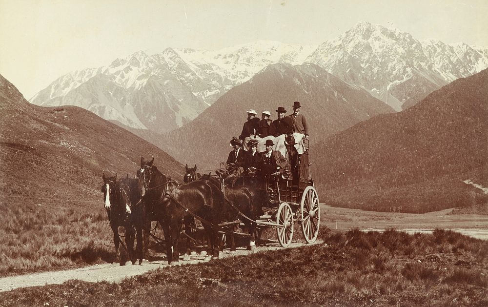 Horse-drawn coach in a scenic valley.  From the album: Skerman family album (circa 1920).