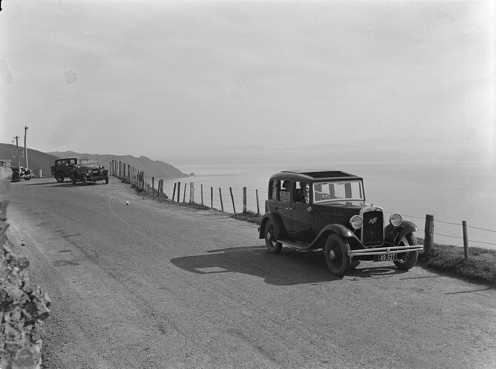 Cars on hillside road (1920s-1930s).