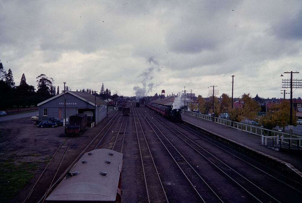 Ashburton rly. station (Canterbury Plains landscape) from the overhead bridge (24 March 1959-13 April1959) by Leslie Adkin.