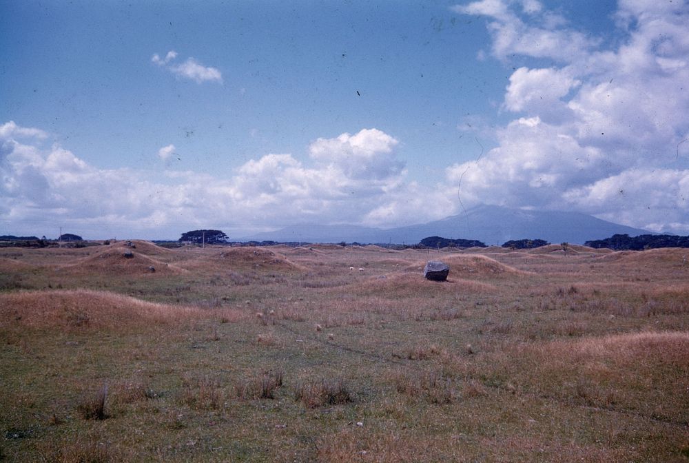 Group of small-size lahar hillocks between Pihama and Opunake, Mt Egmont under cloud to right (01 February 1960) by Leslie…