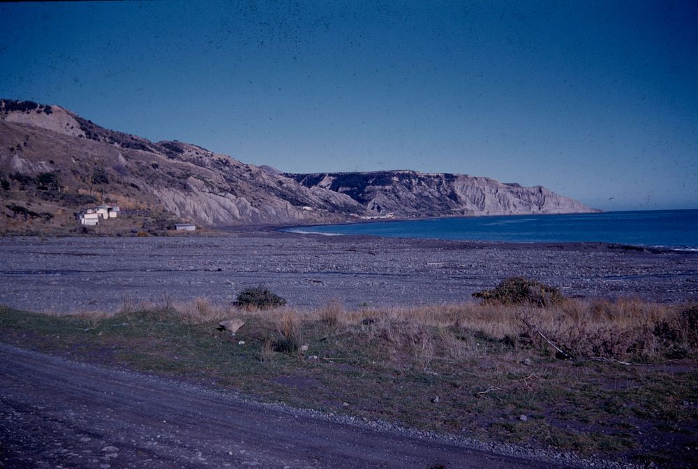 Palliser Bay - NE coast from mouth of Putangirua River looking southward (28 May 1961) by Leslie Adkin.