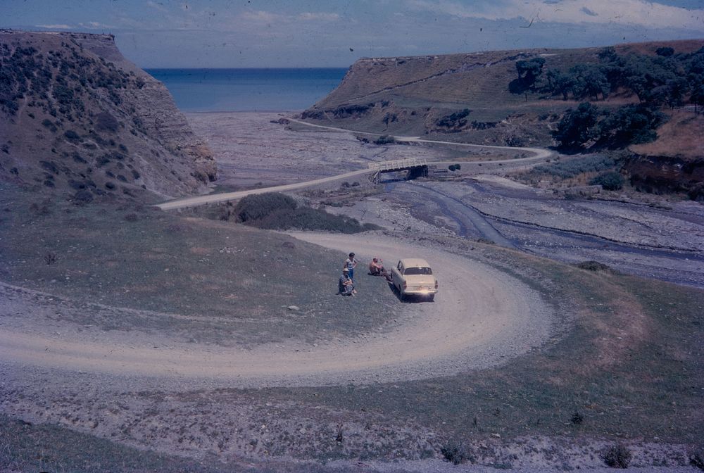 The descent into the narrow lower valley of the Wharekauhau River, Palliser Bay in distance (21 January 1963) by Leslie…