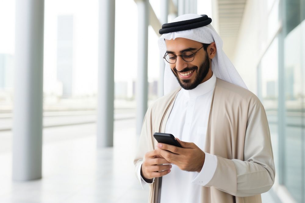 Arab man using mobile phone adult city architecture. AI generated Image by rawpixel.