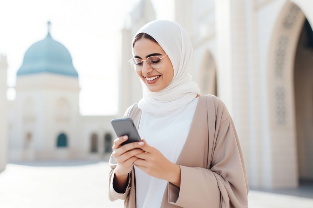 Arab woman using mobile phone happy city spirituality. AI generated Image by rawpixel.