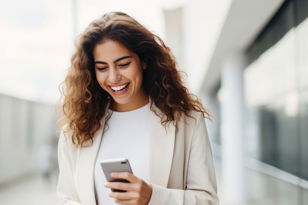 Latin woman using mobile phone laughing smile adult. AI generated Image by rawpixel.