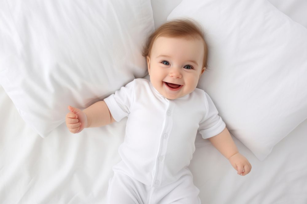 Smiling newborn baby portrait white bed. AI generated Image by rawpixel.