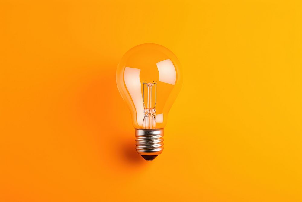 A light bulb lightbulb lamp orange background. AI generated Image by rawpixel.