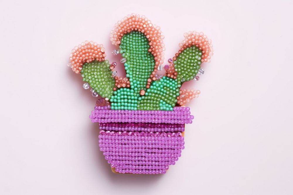 Cactus in pot bead embroidery jewelry. AI generated Image by rawpixel.