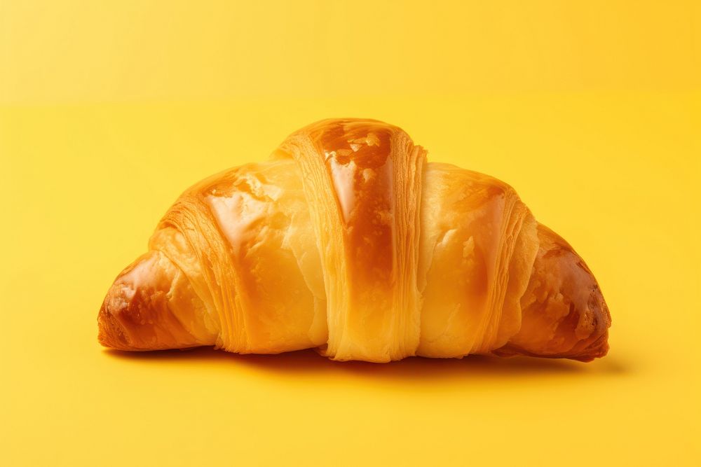 A croissant yellow bread food. AI generated Image by rawpixel.