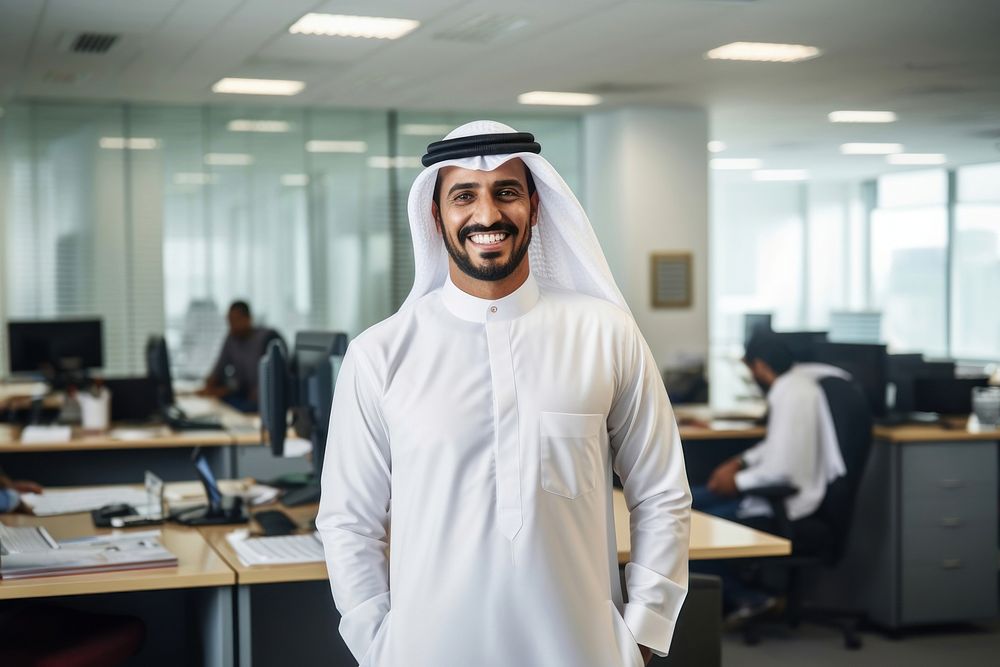 Emirati Arab at office wearing Kandura standing looking adult. AI generated Image by rawpixel.