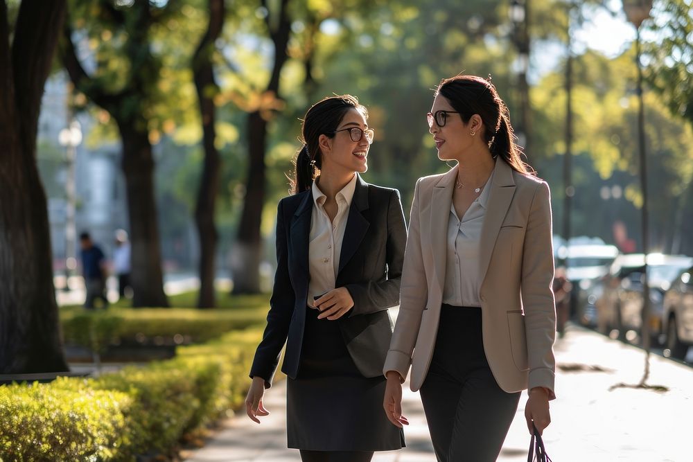 Business women walking blazer togetherness architecture. AI generated Image by rawpixel.