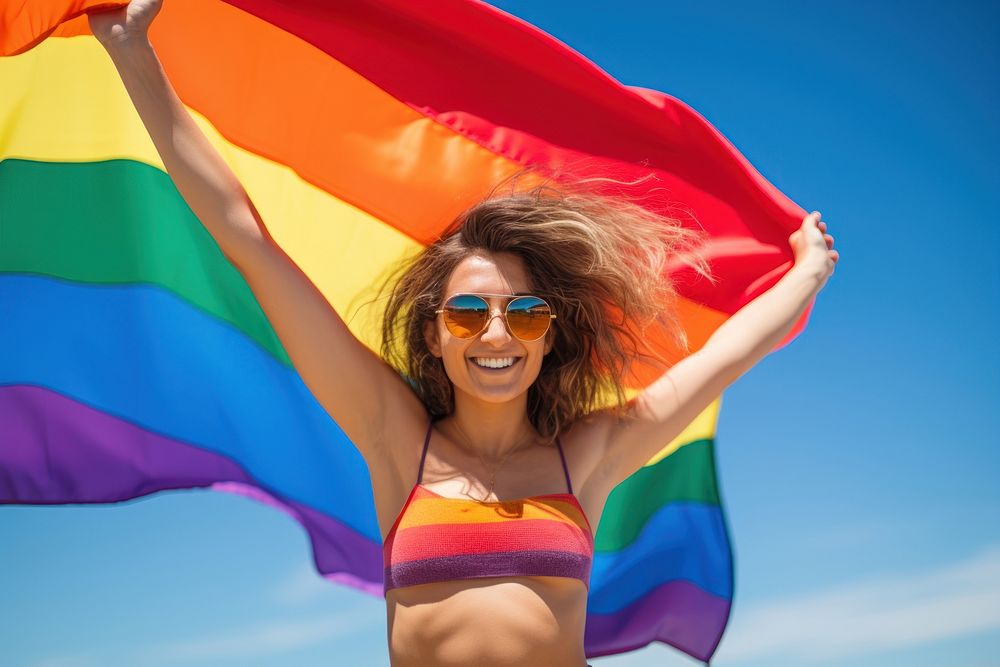 Woman holding a Gay Rainbow Flag happiness swimwear rainbow. AI generated Image by rawpixel.