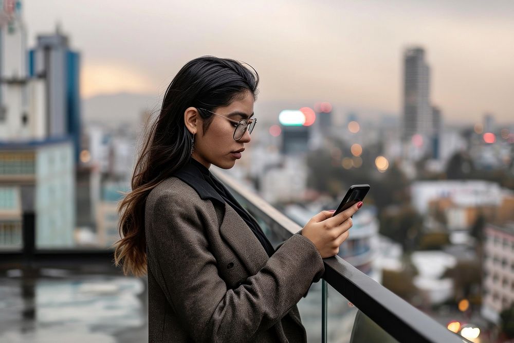 Woman looking at her phone adult photo city. AI generated Image by rawpixel.