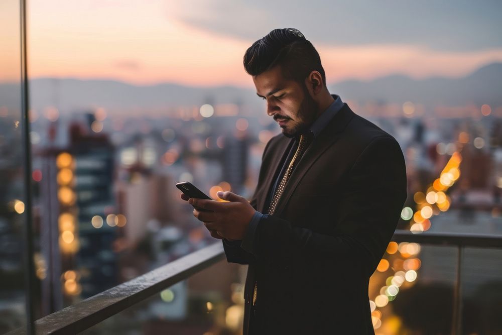 Man in suit looking at his phone adult photo city. AI generated Image by rawpixel.