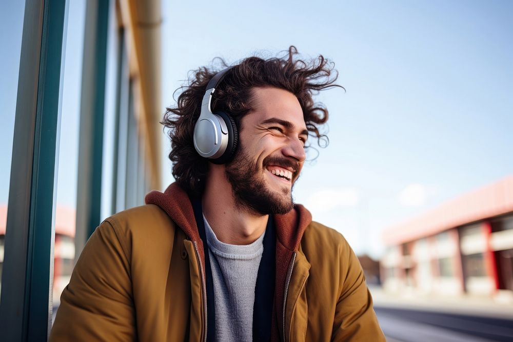 Happy young man headphones listening outdoors. AI generated Image by rawpixel.