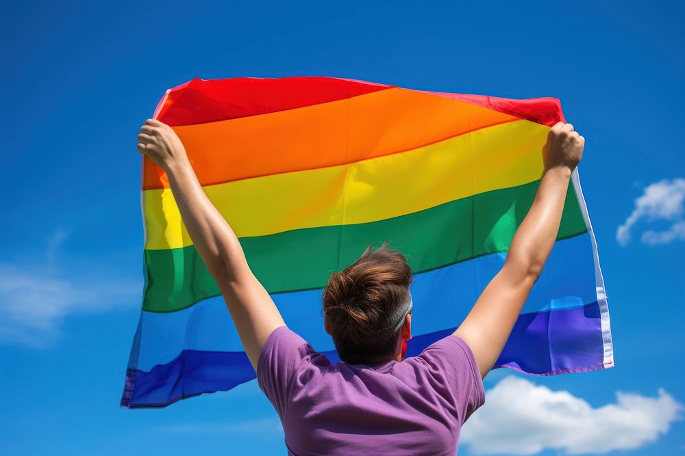 Man holding a Gay Rainbow Flag flag rainbow pride. AI generated Image by rawpixel.