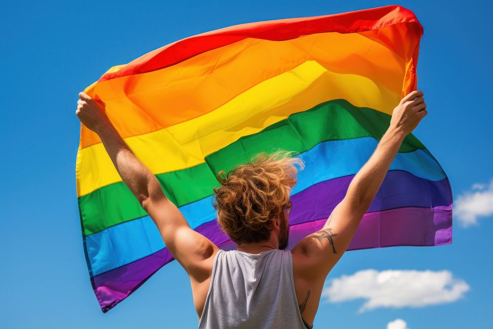 Man holding a Gay Rainbow Flag rainbow blue flag. AI generated Image by rawpixel.