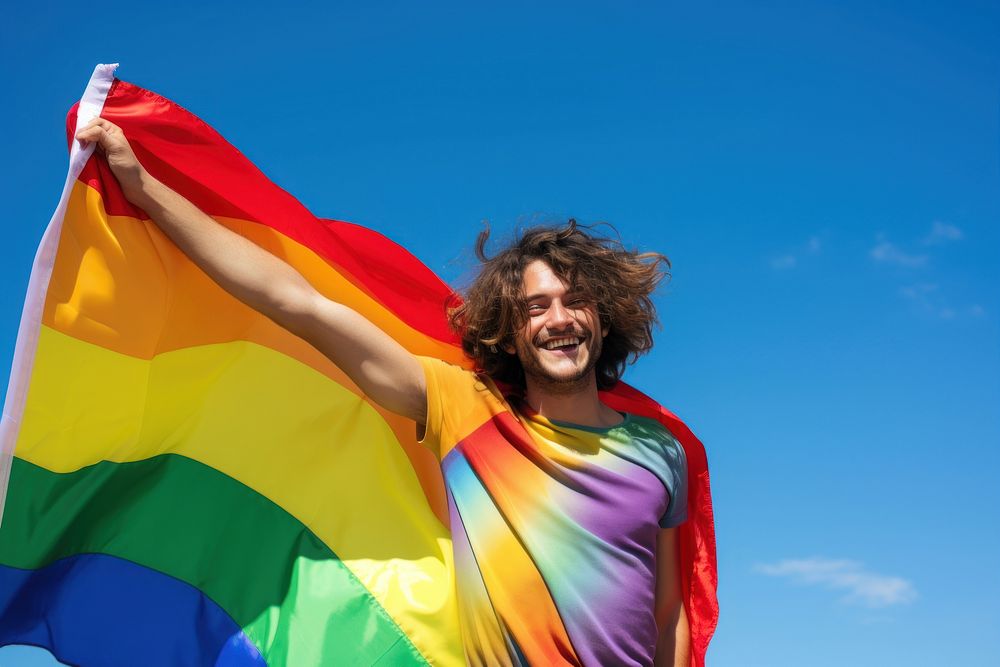 Man holding a Gay Rainbow Flag flag happiness rainbow. AI generated Image by rawpixel.