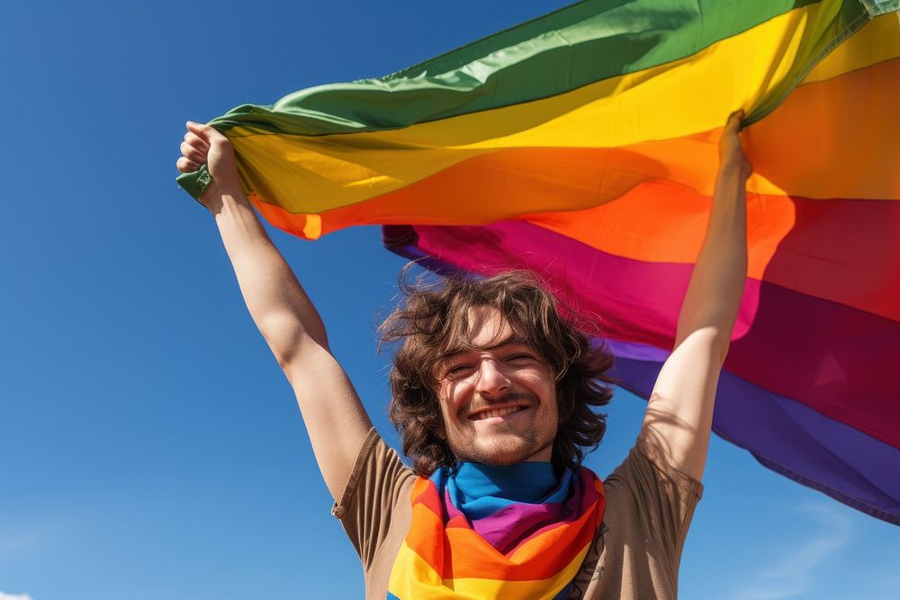 Man holding a Gay Rainbow Flag flag happiness rainbow. AI generated Image by rawpixel.